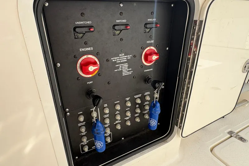 Slide: The Image of Control panel of a 2020 Boston Whaler 330 Outrage boat with switches and keys. - 24