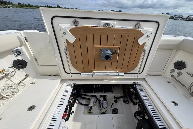 Slide: The Image of The image shows the engine compartment of a 2020 Boston Whaler 330 Outrage with an open hatch. - 18