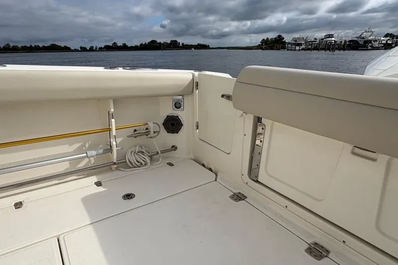 Slide: The Image of 2020 Boston Whaler 330 Outrage boat interior, featuring spacious deck and seating area. - 22