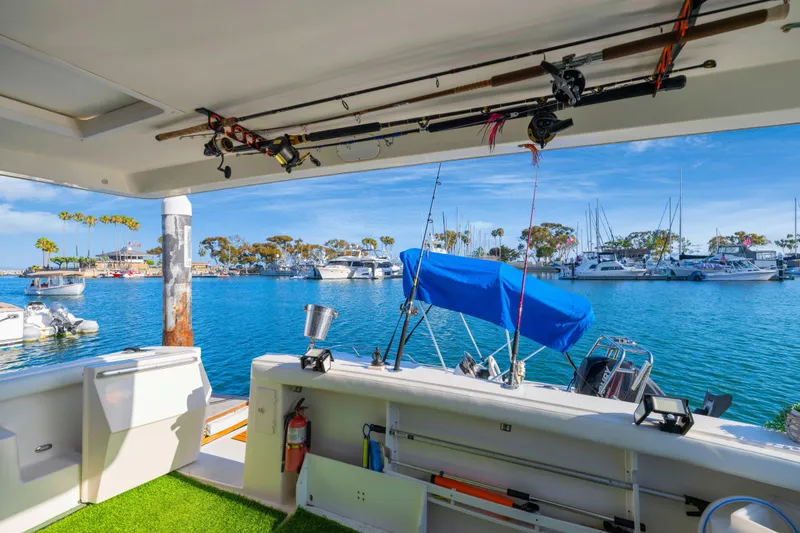 Slide: The Image of 1998 Bayliner 4788 Pilot House Motoryacht docked in scenic marina with fishing gear. - 38