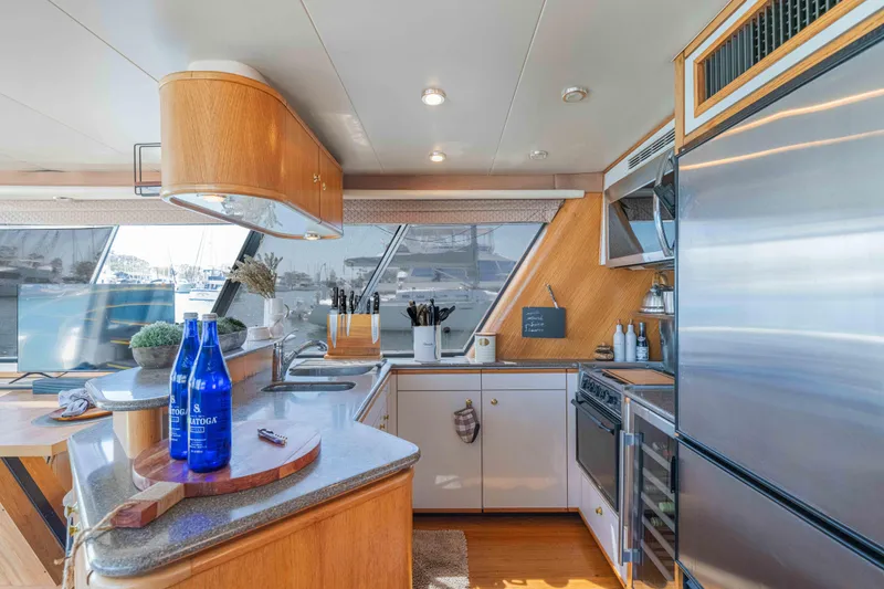 Slide: The Image of Luxurious kitchen interior of 1998 Bayliner 4788 Pilot House Motoryacht with modern amenities. - 7