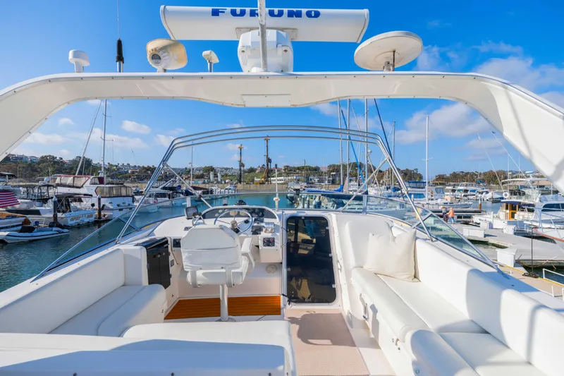 Slide: The Image of 1998 Bayliner 4788 Pilot House Motoryacht at marina, featuring spacious helm and seating area. - 30