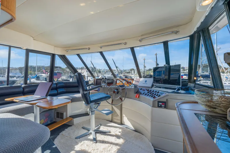 Slide: The Image of Interior of 1998 Bayliner 4788 Pilot House Motoryacht with helm, seating, and panoramic windows. - 21