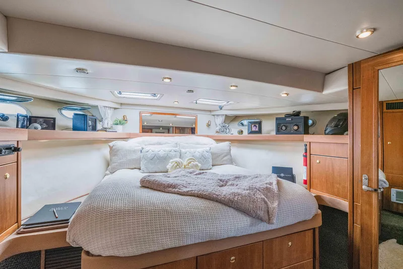 Slide: The Image of Luxurious bedroom interior of 1998 Bayliner 4788 Pilot House Motoryacht with cozy bedding and elegant decor. - 17