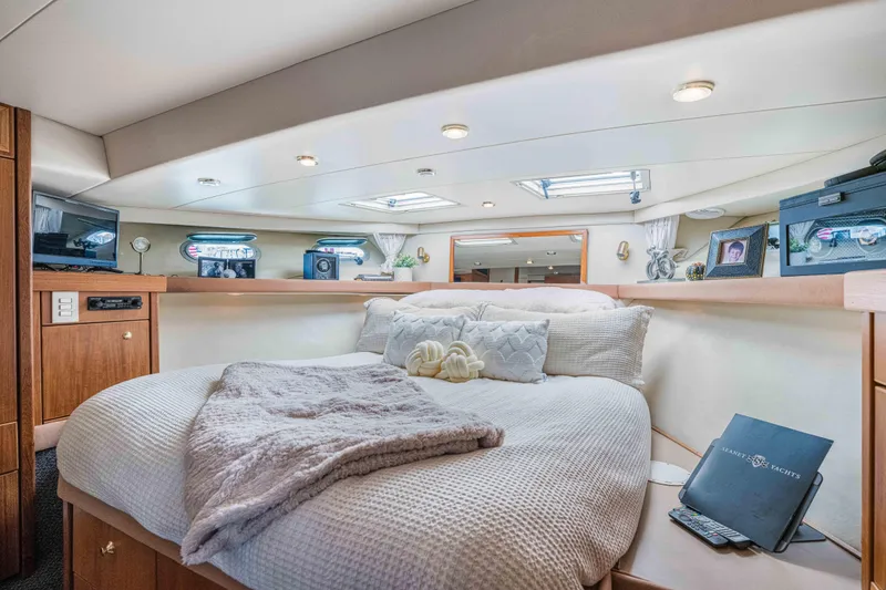 Slide: The Image of Luxurious bedroom interior of 1998 Bayliner 4788 Pilot House Motoryacht with cozy bedding and decor. - 19