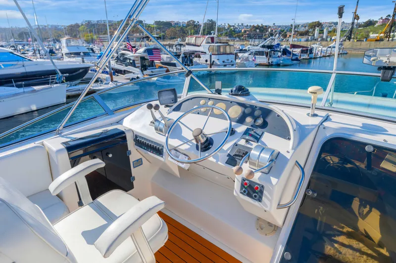 Slide: The Image of Cockpit of 1998 Bayliner 4788 Pilot House Motoryacht in marina setting. - 29