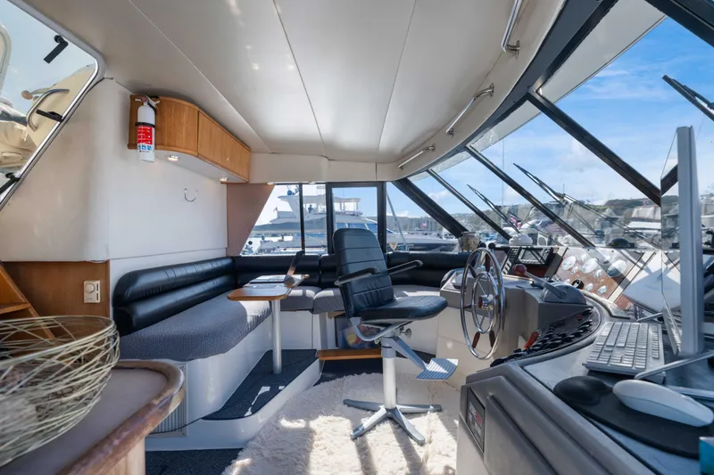Slide: The Image of Interior of 1998 Bayliner 4788 Pilot House Motoryacht with helm, seating, and panoramic windows. - 22