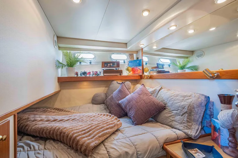 Slide: The Image of Cozy cabin interior of 1998 Bayliner 4788 Pilot House Motoryacht with plush bedding and decor. - 14