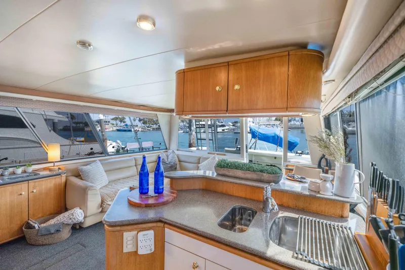 Slide: The Image of Luxurious interior of a 1998 Bayliner 4788 Pilot House Motoryacht with elegant furnishings and marina view. - 11