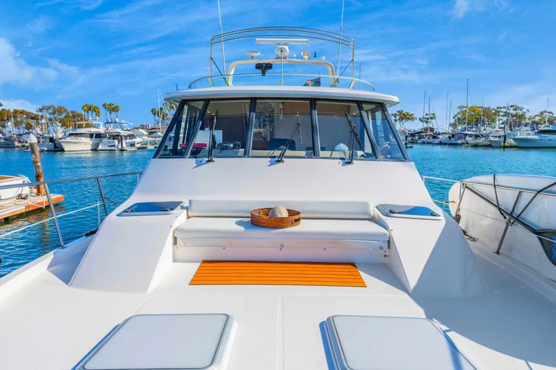 Slide: The Image of 1998 Bayliner 4788 Pilot House Motoryacht docked in a sunny marina. - 24