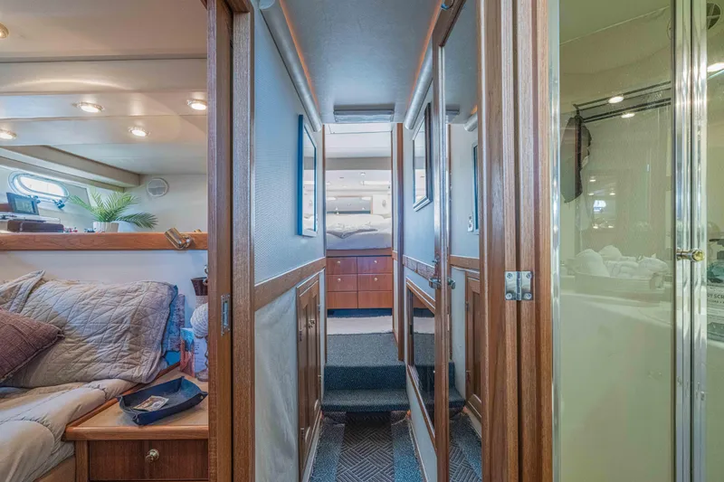 Slide: The Image of Interior of 1998 Bayliner 4788 Pilot House Motoryacht, featuring cozy cabin and hallway. - 13