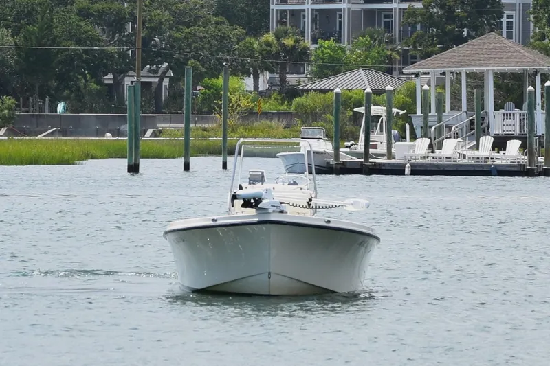 The Image of 2005 Parker 1801 Center Console boat on calm water near a dock. - 0