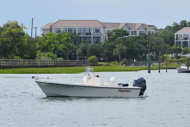 Slide: The Image of 2005 Parker 1801 Center Console boat on water near residential area. - 4