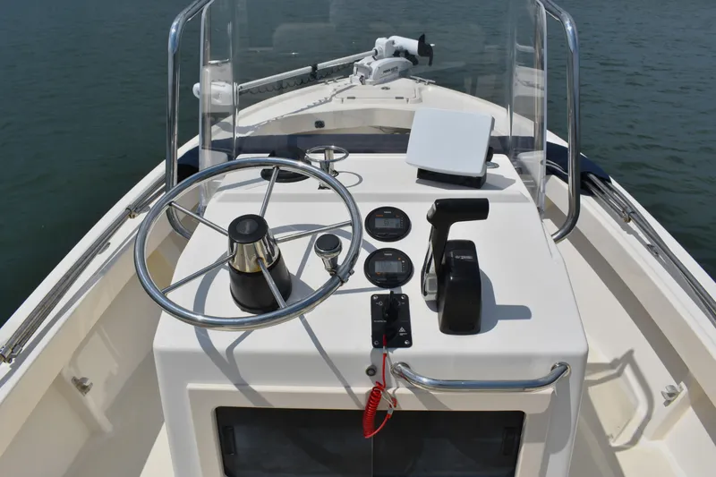 Slide: The Image of 2005 Parker 1801 Center Console boat dashboard with steering wheel and controls. - 11