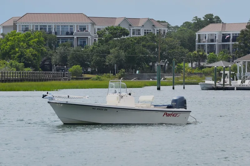 Slide: The Image of 2005 Parker 1801 Center Console boat on water near residential area. - 5
