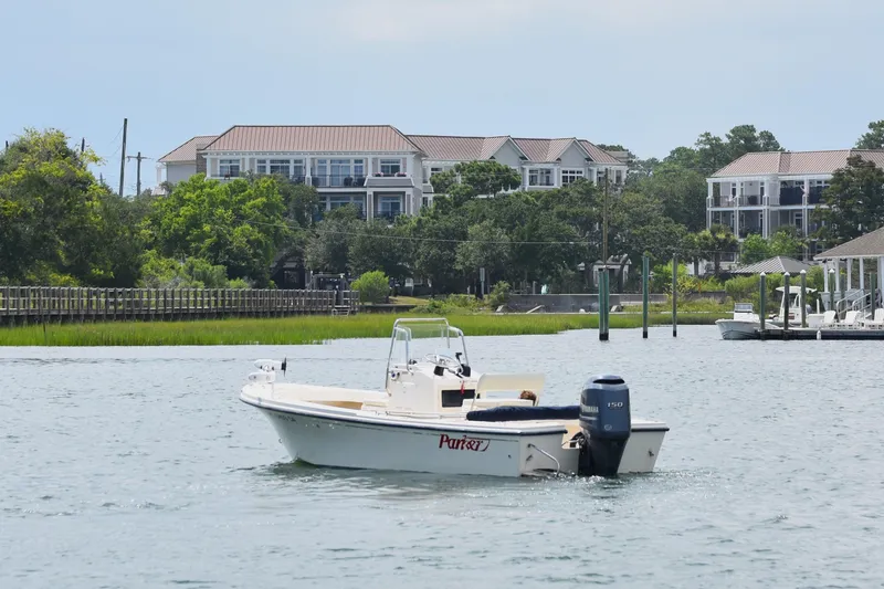 Slide: The Image of 2005 Parker 1801 Center Console boat on water near residential area. - 3