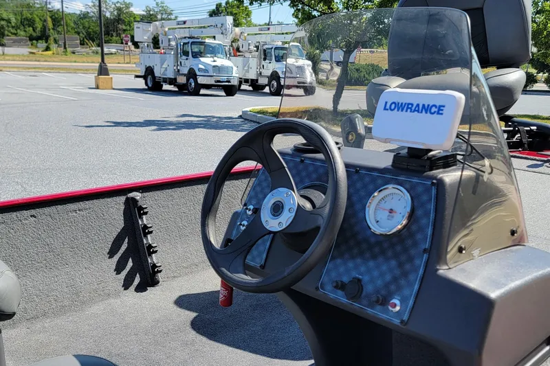 Slide: The Image of 2024 Tracker Bass Tracker Classic XL boat dashboard with Lowrance device in a parking lot. - 7