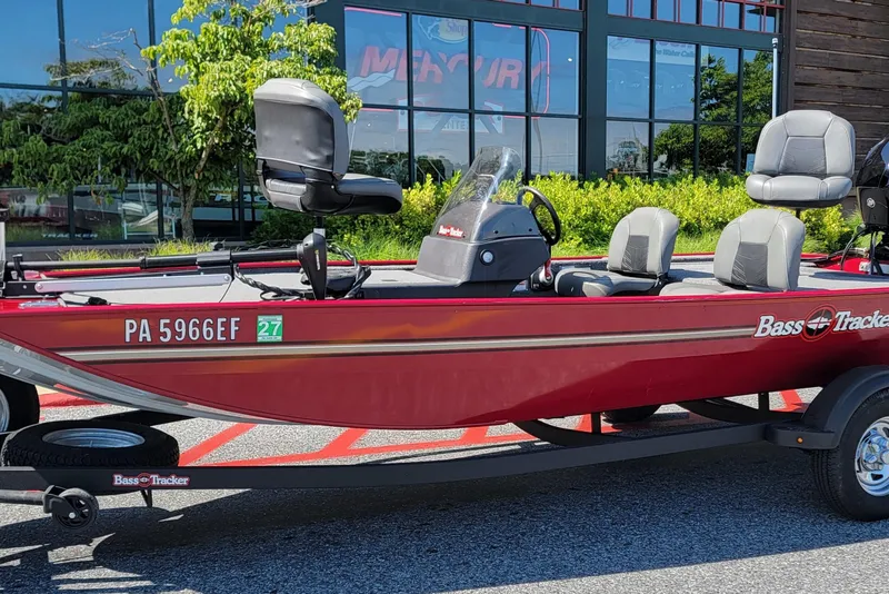 The Image of 2024 Tracker Bass Tracker Classic XL boat in red, parked outdoors on a sunny day. - 0