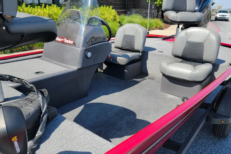 Slide: The Image of 2024 Tracker Bass Tracker Classic XL boat interior with gray seating and steering console. - 4