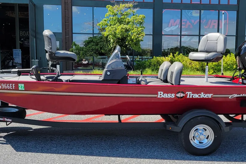 Slide: The Image of 2024 Tracker Bass Tracker Classic XL boat parked outside a showroom. - 5