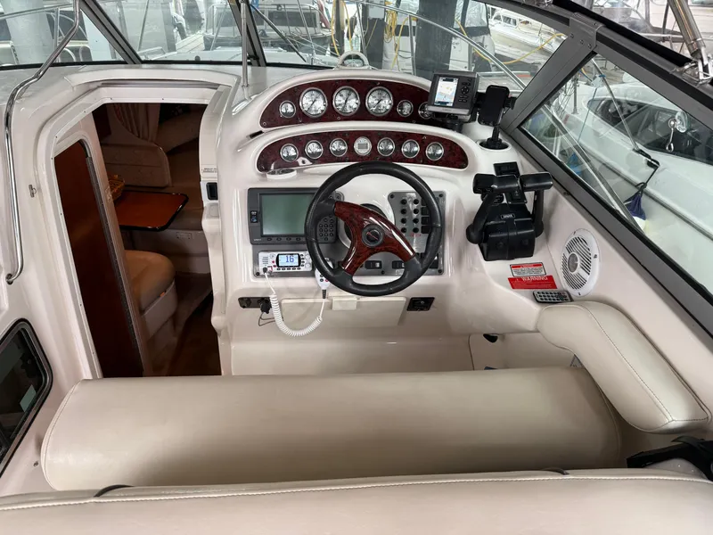 Slide: The Image of 2003 Monterey 302 Cruiser helm with gauges, steering wheel, and navigation equipment. - 3