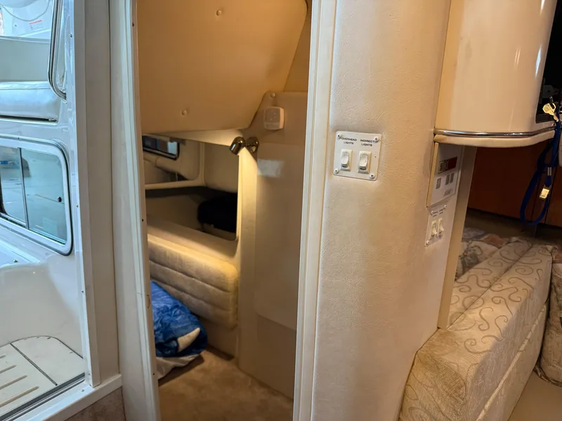 Slide: The Image of Interior of a 2003 Monterey 302 Cruiser boat, featuring cozy sleeping quarters. - 37
