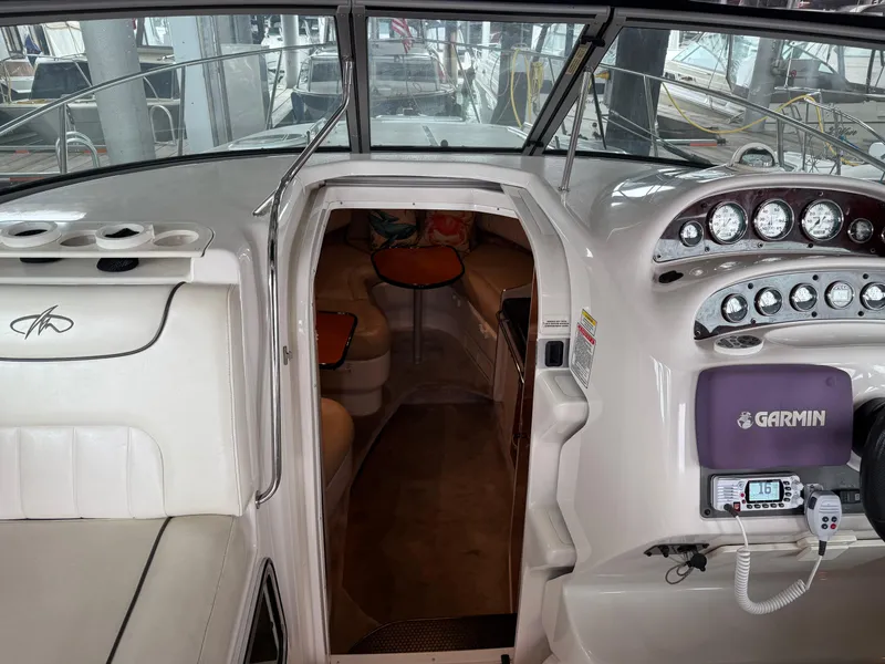 Slide: The Image of 2003 Monterey 302 Cruiser interior with navigation equipment and seating area. - 18