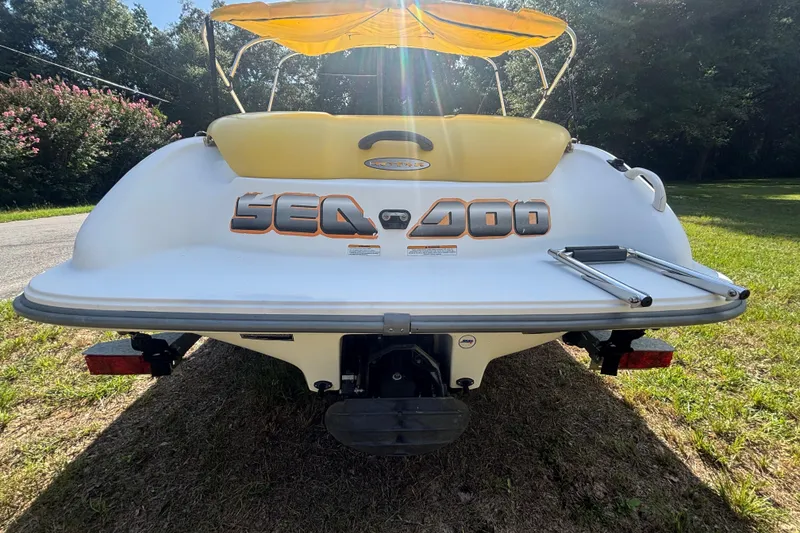 Slide: The Image of 2004 Sea-Doo Sportster LE DI boat with yellow canopy, rear view on grass. - 3
