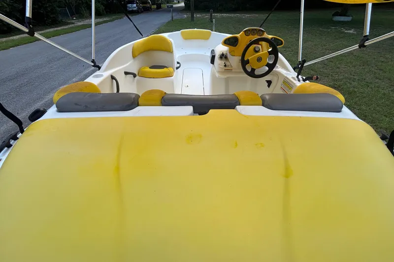 Slide: The Image of 2004 Sea-Doo Sportster LE DI boat interior with yellow seating and steering wheel. - 12