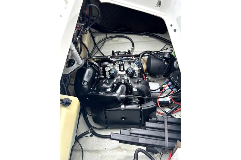 Slide: The Image of Engine compartment of a 2004 Sea-Doo Sportster LE DI boat, showcasing intricate wiring and components. - 7