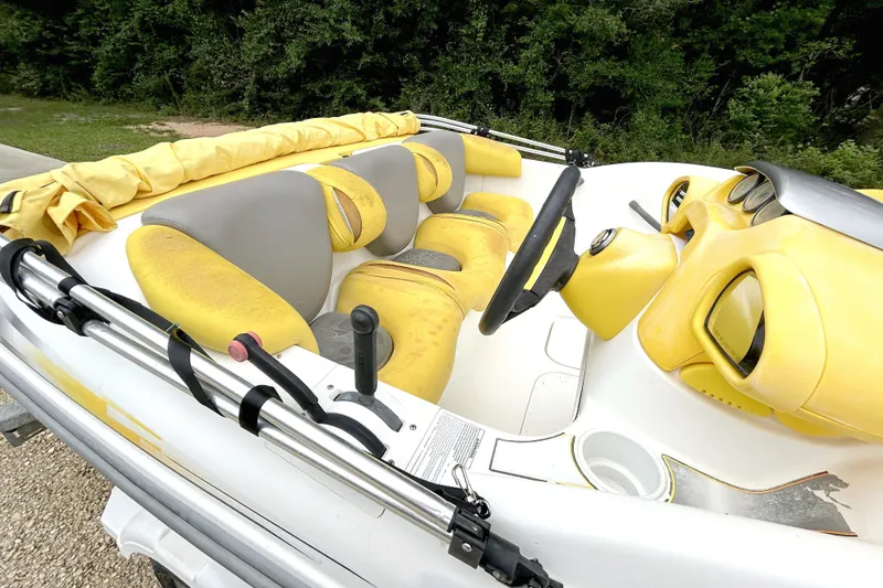 Slide: The Image of 2004 Sea-Doo Sportster LE DI boat interior with yellow and gray seating, steering wheel, and controls. - 5