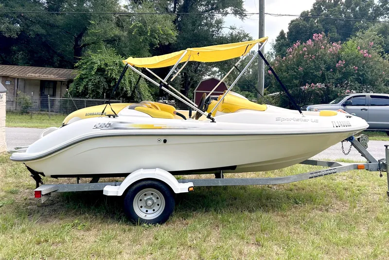 The Image of 2004 Sea-Doo Sportster LE DI boat with yellow canopy on trailer, parked outdoors. - 1