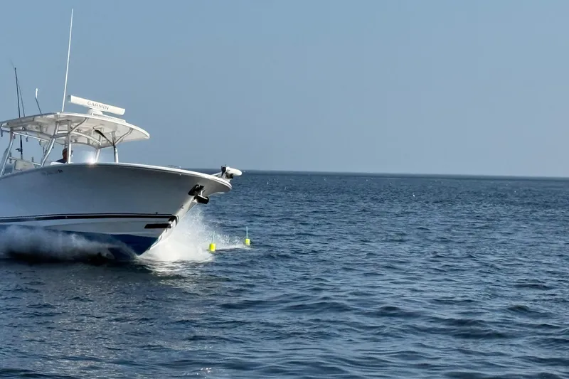 Slide: The Image of 2020 Southport 33 FE boat cruising on open water under clear blue sky. - 20