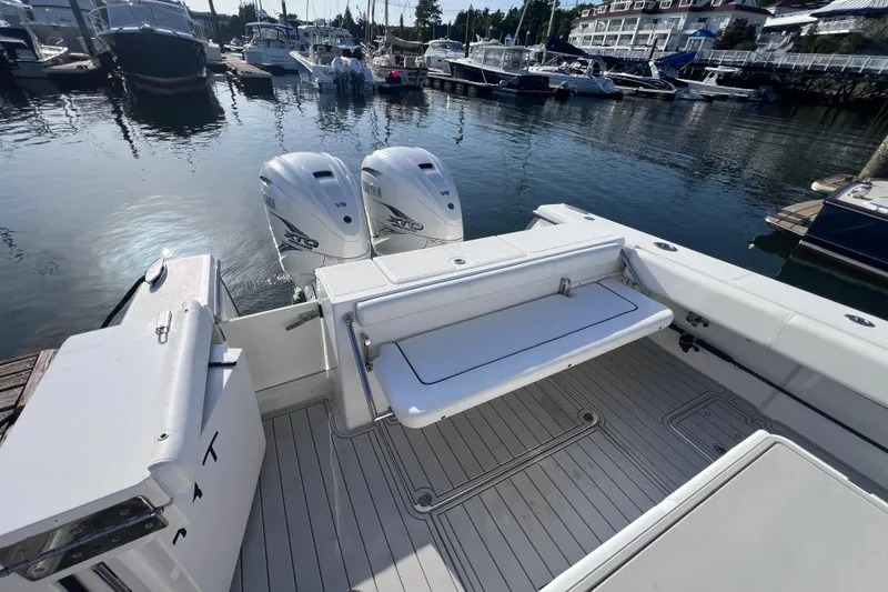 Slide: The Image of 2020 Southport 33 FE boat with dual engines docked at a marina. - 26