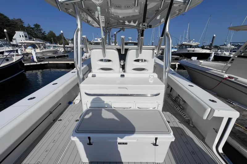 Slide: The Image of 2020 Southport 33 FE boat interior at marina, featuring seating and storage. - 31