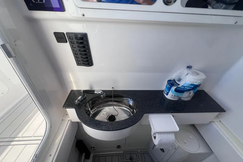 Slide: The Image of Compact bathroom sink area on a 2020 Southport 33 FE boat, featuring a countertop and faucet. - 40
