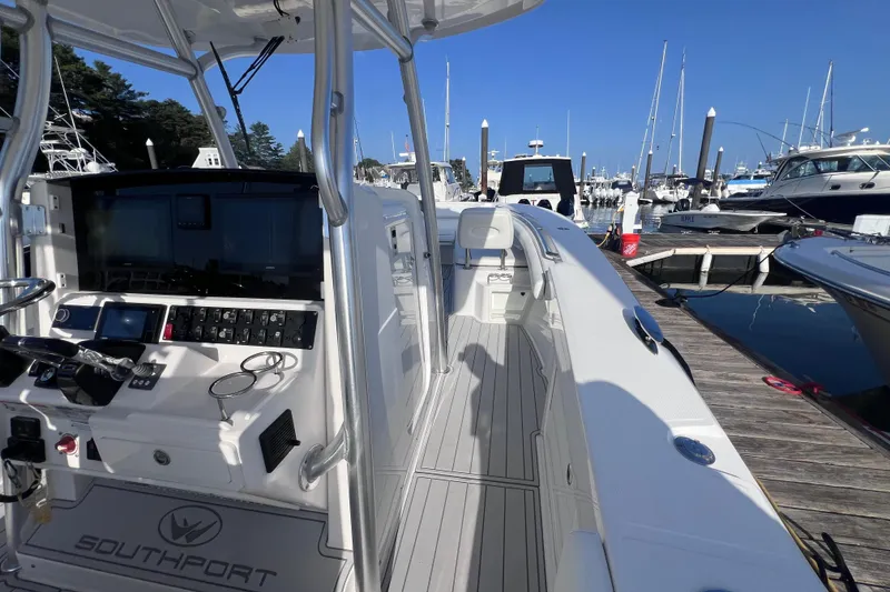 Slide: The Image of 2020 Southport 33 FE boat docked at marina, showcasing helm and sleek design. - 37
