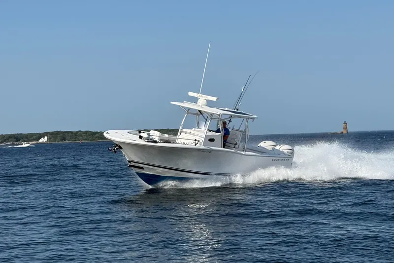 Slide: The Image of 2020 Southport 33 FE boat cruising on open water under clear blue sky. - 13