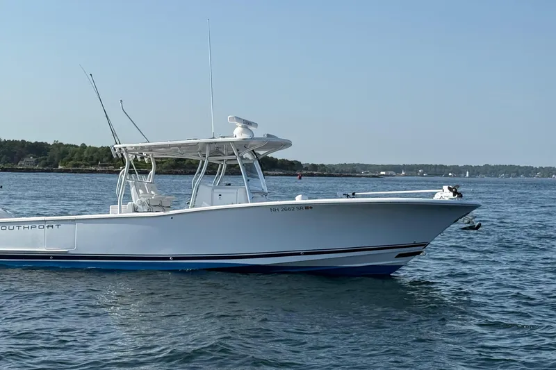 Slide: The Image of 2020 Southport 33 FE boat on calm water, clear sky background. - 5