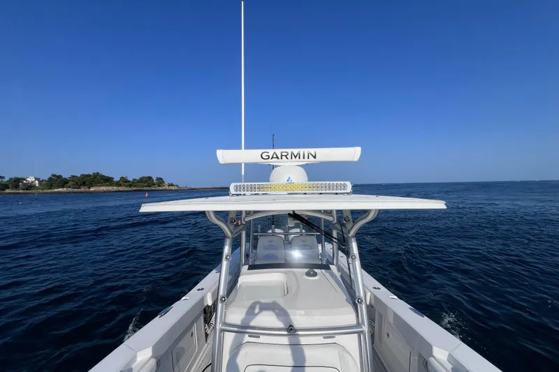 Slide: The Image of 2020 Southport 33 FE boat on open water, featuring Garmin equipment under clear blue skies. - 23