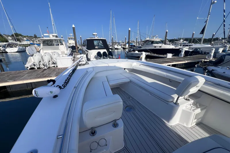 Slide: The Image of 2020 Southport 33 FE boat docked in a marina, showcasing spacious seating and sleek design. - 34