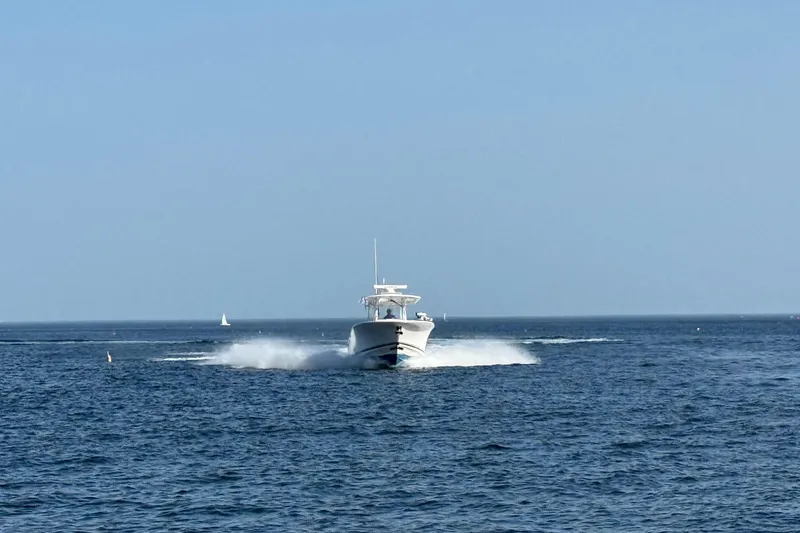Slide: The Image of 2020 Southport 33 FE boat cruising on open sea under clear blue sky. - 18