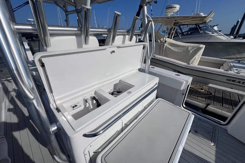 Slide: The Image of 2020 Southport 33 FE boat with open storage compartment at marina. - 28