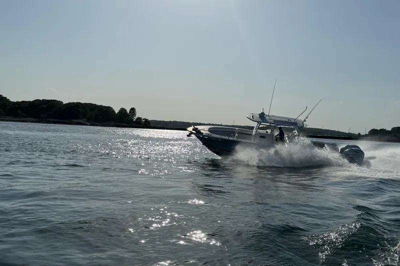 Slide: The Image of 2020 Southport 33 FE boat cruising on a sunny day, creating waves in open water. - 15