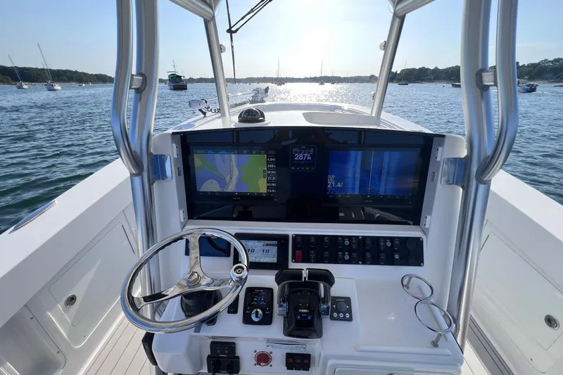 Slide: The Image of 2020 Southport 33 FE boat helm with navigation screens on a sunny day. - 25