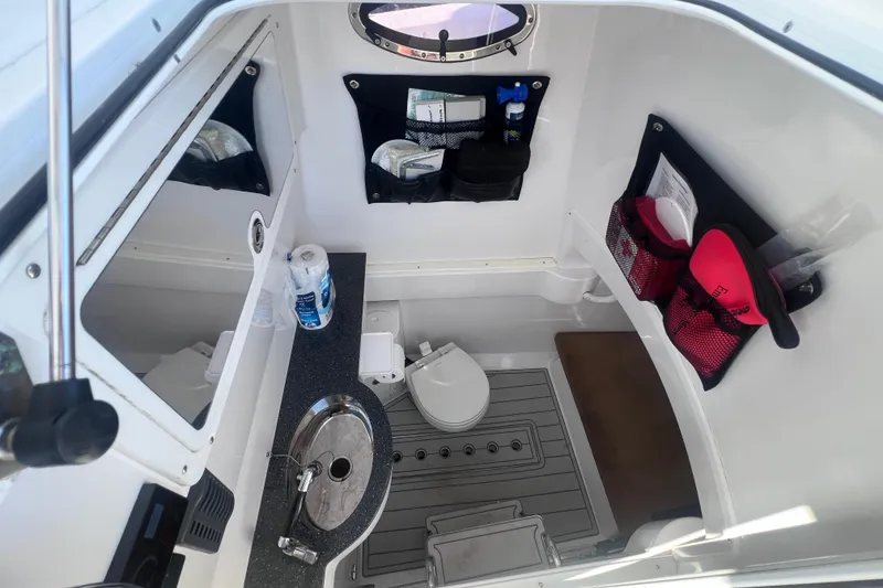 Slide: The Image of 2020 Southport 33 FE boat interior with sink, toilet, and storage compartments. - 41