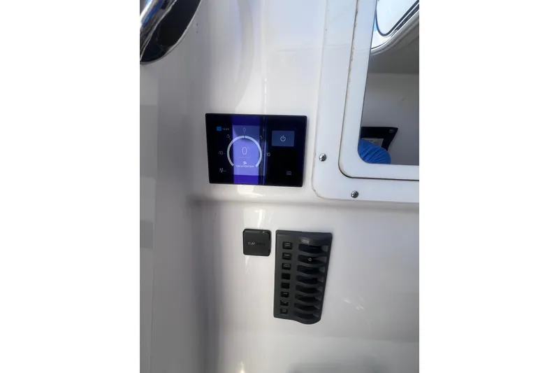 Slide: The Image of Control panel of a 2020 Southport 33 FE boat with digital display and switches. - 39