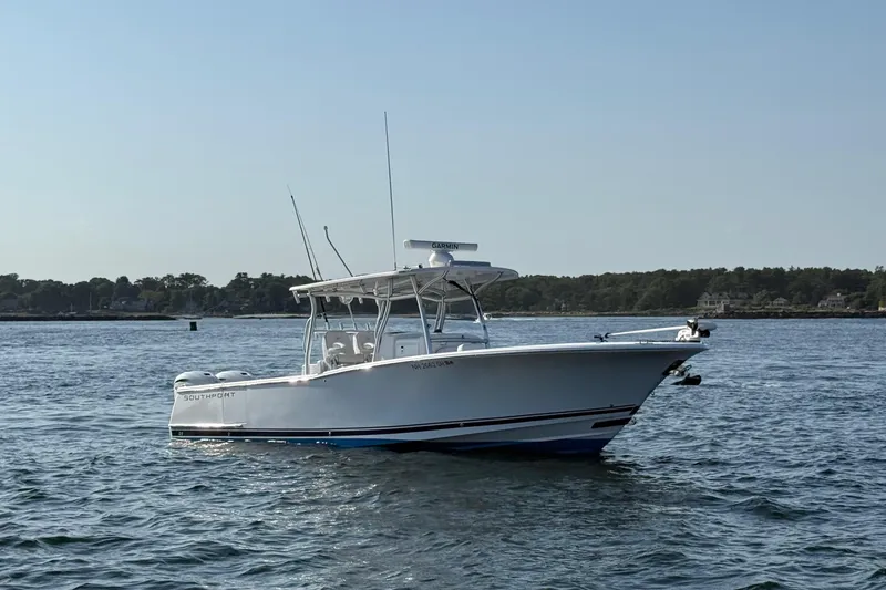 Slide: The Image of 2020 Southport 33 FE boat on calm water, clear sky background. - 4