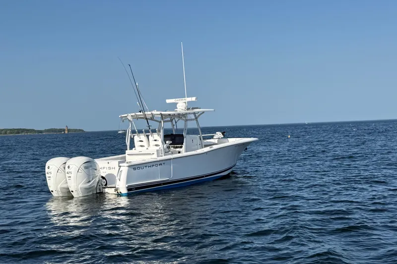Slide: The Image of 2020 Southport 33 FE boat on open water, featuring twin engines and clear blue sky. - 8