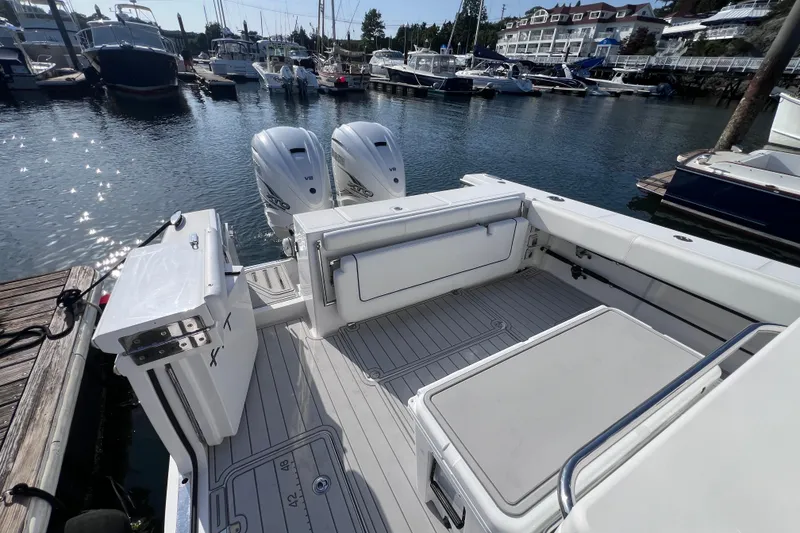 Slide: The Image of 2020 Southport 33 FE boat with twin engines docked at a marina. - 21